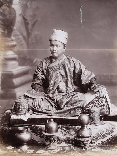 A Shan chief sits three-quarter face, his left hand resting on a cushion. (1906)