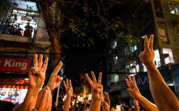 People give a three-finger salute after calls for protest went out on social media in Yangon on Feb 3, 2021 following the coup. (AFP)