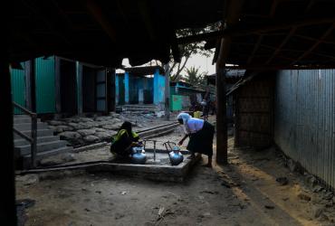 Rohingya refugee woman collect water from a tube well at Nayapara Rohingya refugee camp in Bangladesh's Teknaf district on April 6, 2018. (Munir Uz Zaman / AFP)