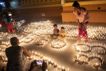 Buddhist devotees light candles at a pagoda during the Thadingyut festival in Bago last October. Thadingyut festival, the festival of Lights, is held during the full moon on the lunar month of Thadingyut and marks the end of the Buddhist Lent. (Ye Aung Thu / AFP)