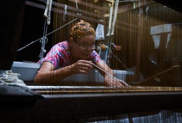  Rampai Sripetch, a 65-year-old Thai Muslim woman, weaves silk fabric on a loom at a workshop near Darul Falah mosque in Bangkok. (Romeo Gacad / AFP)