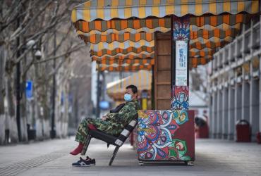  This photo taken on February 29, 2020 shows a man wearing a face mask sitting on a chair in Wuhan in China's central Hubei province. (STR / AFP)