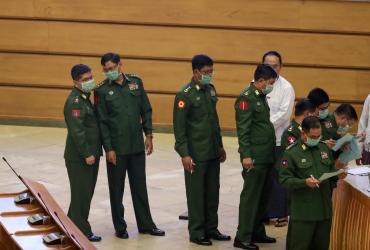 Military officers wearing facemasks who serve as members of Myanmar's parliament line up to vote during a session at the Assembly of the Union (Pyidaungsu Hluttaw) in Naypyidaw on March 10, 2020. (Ye Aung Thu / AFP)