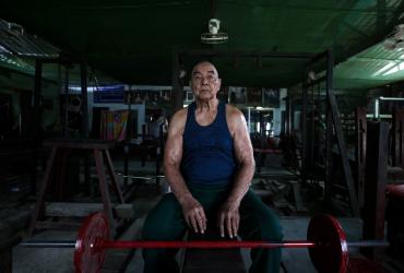 91-year-old bodybuilder Sein Maung poses for a photo as he works out with weights at his gym, which has since been closed due to fears about the spread of the COVID-19 novel coronavirus in Yangon. (Sai Aung Main)