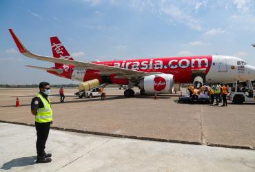 Airport staff unload boxes of COVID-19 coronavirus test kits donated by the European Union and Switzerland under the UN organised humanitarian flight on arrival at Yangon International Airport in Yangon on May 10, 2020.(Sai Aung Main / AFP)