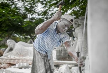 A worker cuts a block of marble for a statue in Sagyin village in Madaya township, about 46km from Mandalay. (Ye Aung Thu / AFP)