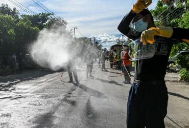  Volunteers spray disinfectant along a street as a preventive measure against the spread of the COVID-19 coronavirus in Yangon on September 13. (Ye Aung Thu / AFP)