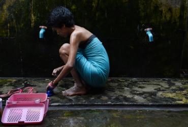 A 26-year old sex worker positive with HIV takes a bath at a treatment centre on the outskirts of Yangon. (Romeo Gacad / AFP)