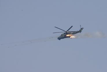 A Myanmar Air Force Mi-35 attack helicopter launches a salvo of rockets during joint military exercises near Pathein city in the Irrawaddy delta region on Febuary 2, 2018. (Lynn Bo Bo / AFP)