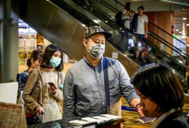 Travellers wearing face masks at Yangon airport. (AFP)