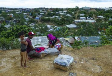 A Rohingya woman buy cloths from a vendor at Kutupalong refugee camp in Ukhia on July 24, 2019. (Munir Uz Zaman / AFP)