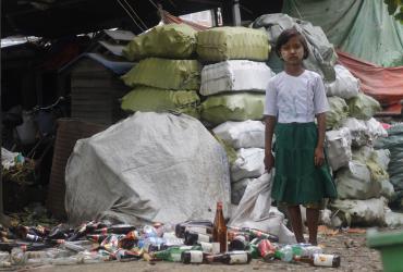 Ei Ei Thein, 13, collects recyclable bottles from rubbish tips to support her family. (Lorcan Lovett / Southeast Asia Globe)