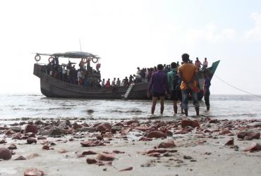 People get off a boat in Bhashan Char island, as it was being prepared for the relocation of Rohingya refugees living in the country’s south after fleeing violence in neighbouring Myanmar. (Polash Shikder / AFP)