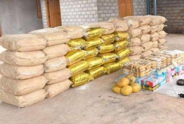 Bags of crystal methamphetamine and yaba pills alongside weapons seized by the Myanmar police photographed near Loikan village, Shan state. (Myanmar Police/UNODC)