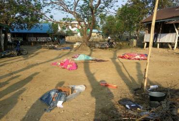 Bodies of policemen, killed in a militant attack, are covered at the Yoetayoke police station, near Sittwe in Rakhine State on March 10, 2019. (STR / AFP)
