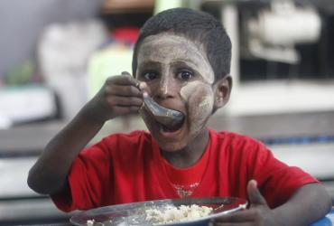 A boy eats lunch at a SONNE Social Organisation centre in Yangon. (Myanmar Mix)