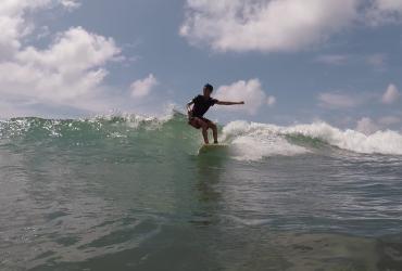 Local surfer Lwin Ko Ko Htet rides a wave on a beach near Ngwe Saung. (Csiga Balazs)