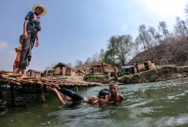 For more than a mile, small huts line the river, partitioned off by bamboo bridges creating numerous self-contained swimming areas. (Dominic Horner)