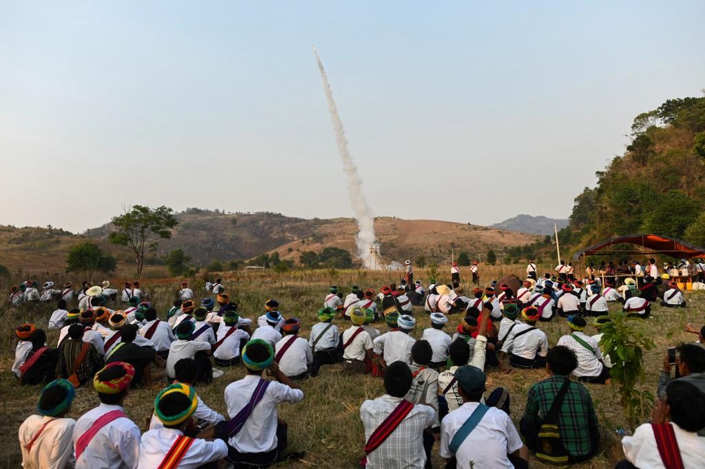  Pa'O ethnic people watch the launching of a homemade rocket during a festival in Nantar, Shan state. (Ye Aung Thu / AFP)