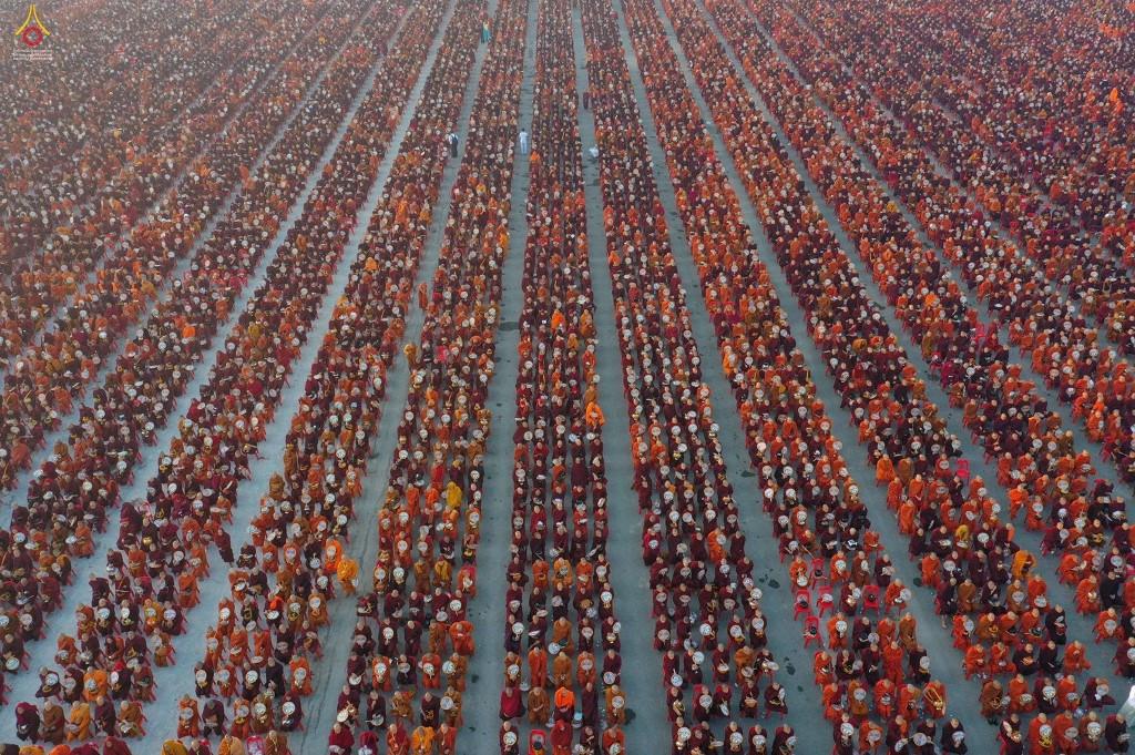 A handout photo taken on December 8, 2019 and released by Dhammakaya Fondation shows monks lining up for alms during the alms-giving ceremony. (AFP / Dhammakaya Foundation)