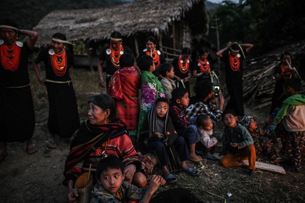 Villagers watch the end of an overnight ceremony to bless the harvest by Naga tribeswomen in Satpalaw Shaung village. (Ye Aung Thu / AFP)