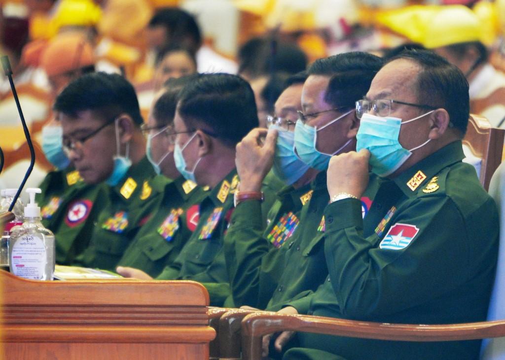 The military-appointed members of parliament wear face masks amid fears about the spread of COVID-19 while attending a session in Naypyidaw on March 4. (Thet Aung / AFP)