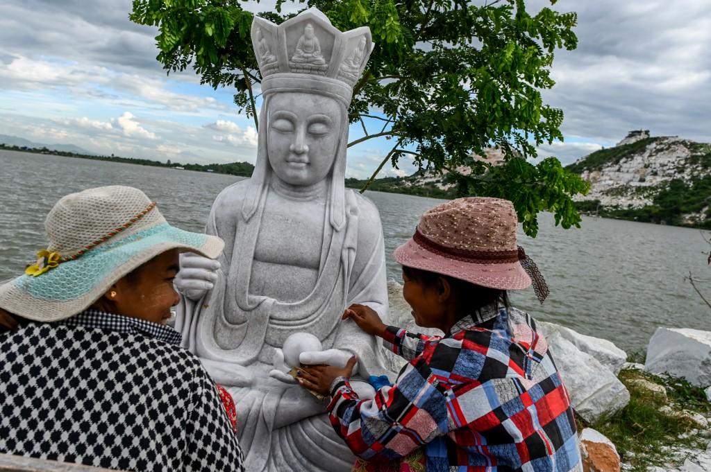 Workers clean a marble statue in Sagyin village. (Ye Aung Thu / AFP)