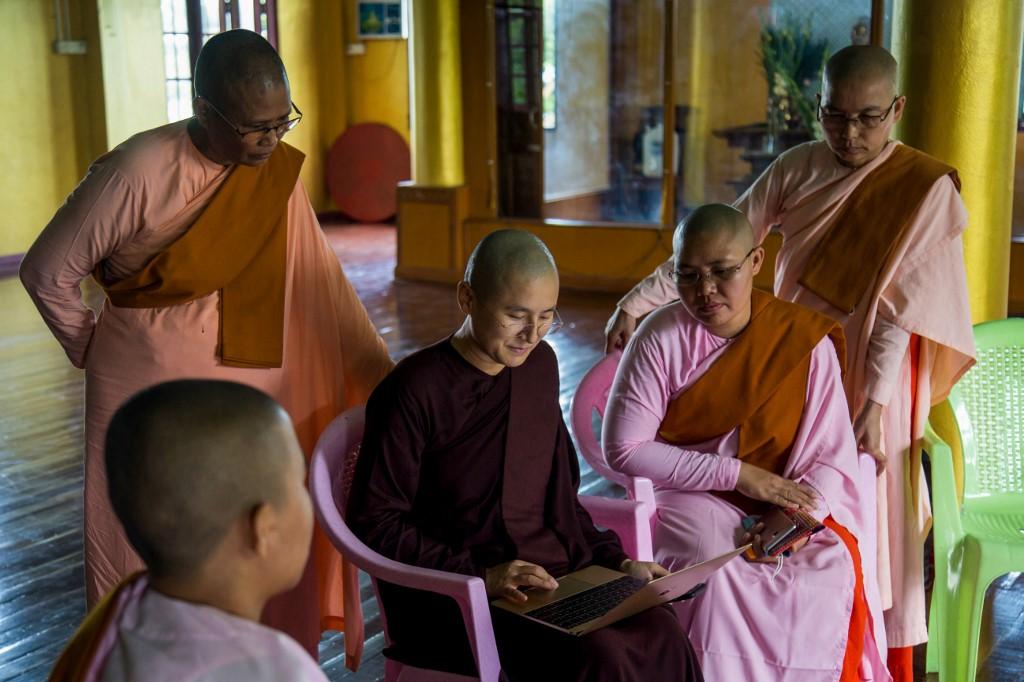 Myanmar Buddhist nun Ketumala shows others how to use a laptop for a Zoom group meeting at a monastery in Yangon. (Sai Aung Main / AFP)