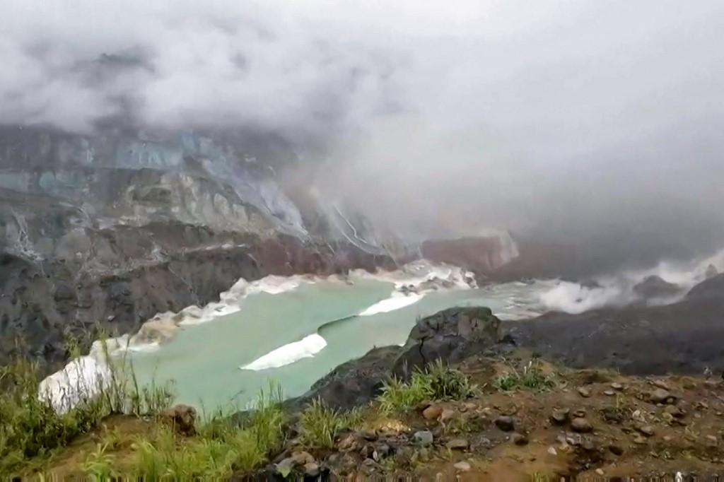 In this file framegrab from a video by David Zahkung taken on July 2, 2020, waves are generated in a lake of mine waste water after a landslide at a jade mine in Hpakant, Kachin state. (David Zahkung / AFP)