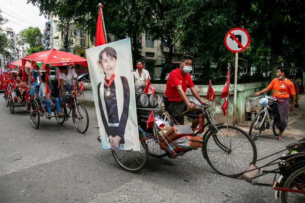 A trishaw driver, who decorated his vehicle with a picture of Aung San Suu Kyi, attends a campaign for the National League for Democracy (NLD) party in Yangon. (Sai Aung Main / AFP)