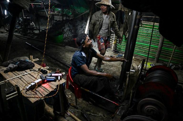  Works operate a machine to extract crude oil from a well at an informal oil field in Minhla township, central Myanmar. (Ye Aung Thu / AFP)