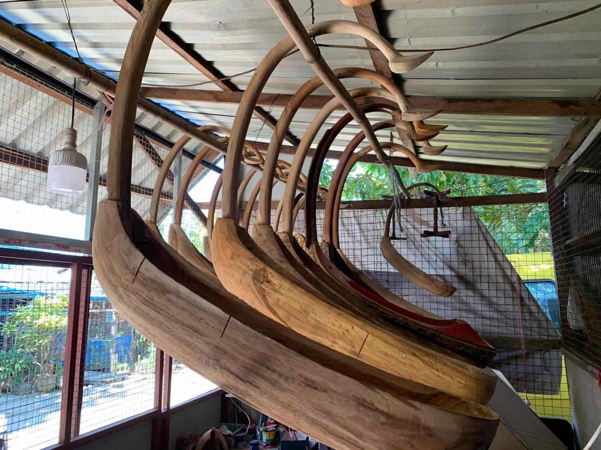 Aye Aung Win hangs the carved wood to dry for two to four years. 