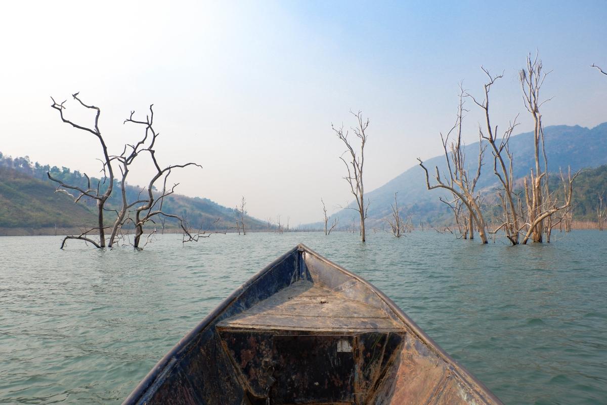 A boat winds its way through a flooded valley to reach Nant Mon Gyi. 