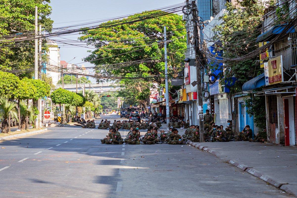 Tatmadaw troops of the notorious 77th Light Infantry Division sit on a road in Sanchaung township. (Ben Small)